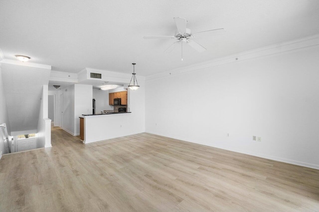 unfurnished living room with ceiling fan, light hardwood / wood-style floors, and ornamental molding