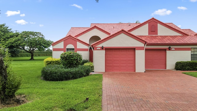 view of front facade with a front yard and a garage