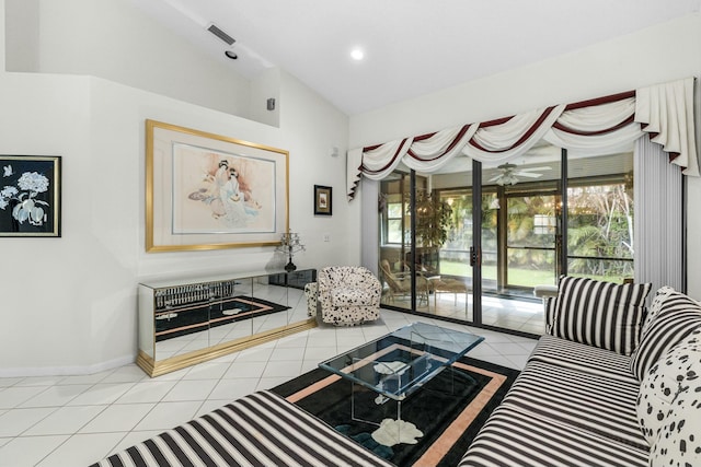 living room featuring lofted ceiling, ceiling fan, and light tile patterned floors