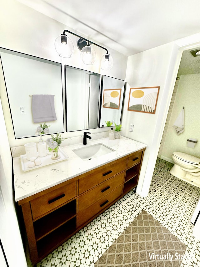 bathroom featuring toilet and vanity