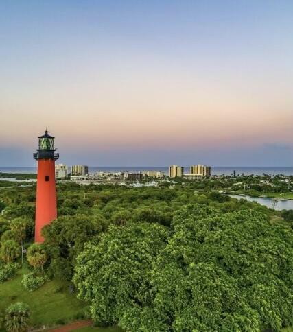 aerial view at dusk featuring a water view