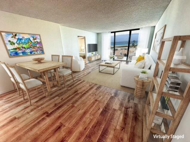 living room featuring a textured ceiling, a wall of windows, and wood-type flooring