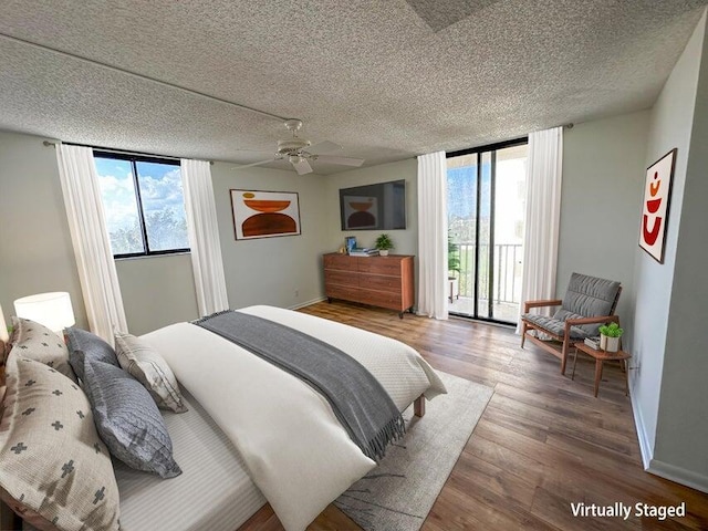 bedroom with wood-type flooring, a textured ceiling, ceiling fan, and access to outside