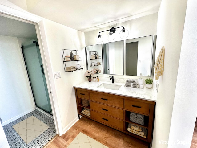 bathroom featuring a shower with door, wood-type flooring, and vanity