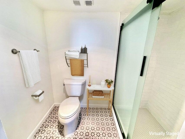 bathroom with an enclosed shower and toilet