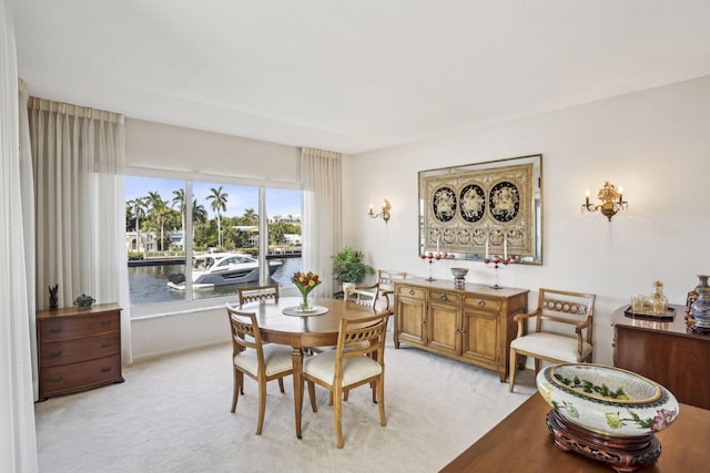 dining space with a healthy amount of sunlight and light carpet