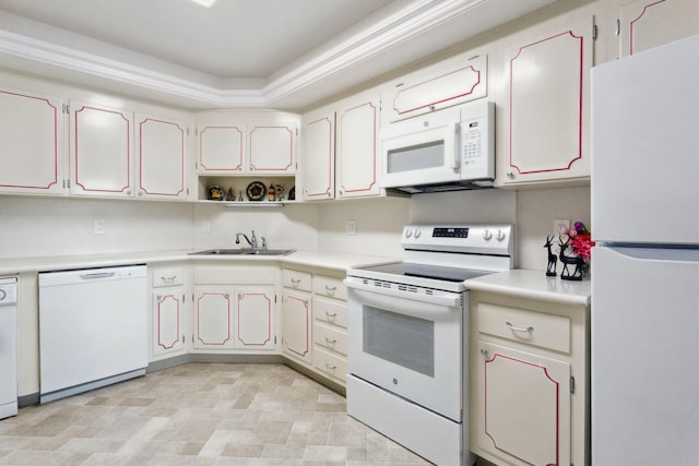 kitchen with white appliances, washer / clothes dryer, white cabinetry, and sink