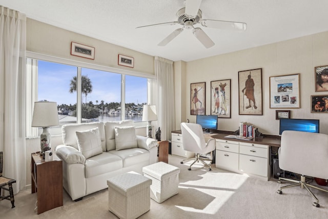 office area featuring ceiling fan and light carpet