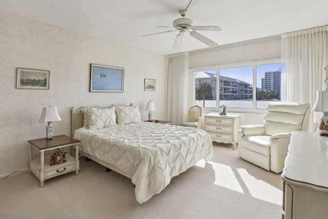 bedroom with ceiling fan and light colored carpet