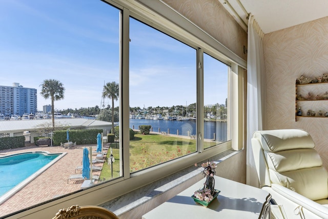 sunroom / solarium with a water view and a healthy amount of sunlight