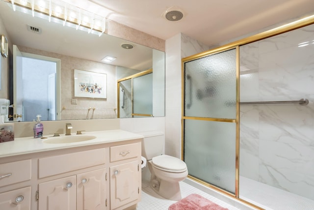 bathroom with a shower with door, vanity, and toilet