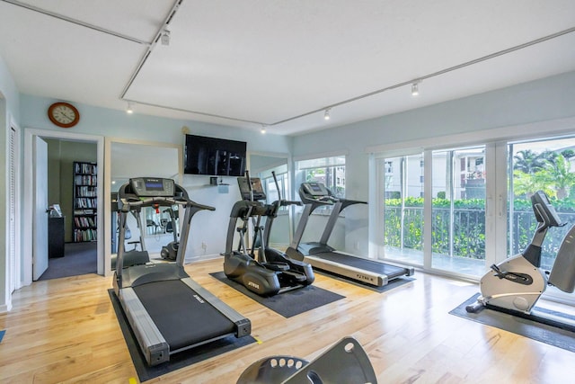 workout area with hardwood / wood-style floors