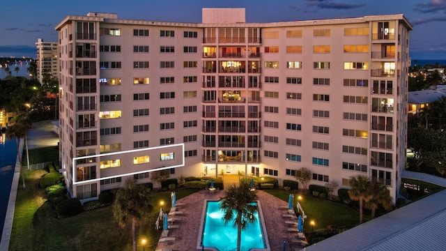 outdoor building at dusk with a community pool