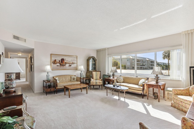 living room featuring light colored carpet and a textured ceiling