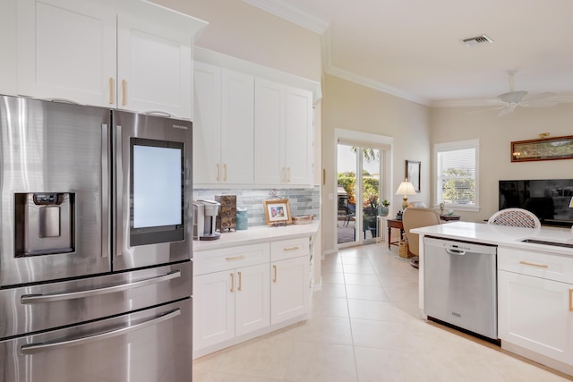 kitchen with white cabinets, ceiling fan, appliances with stainless steel finishes, and tasteful backsplash