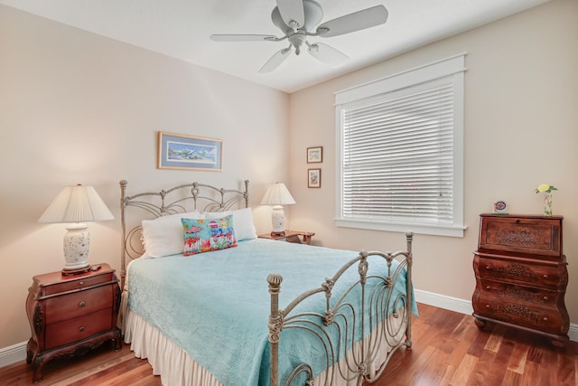 bedroom with ceiling fan and wood-type flooring