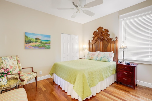 bedroom with hardwood / wood-style flooring, ceiling fan, and a closet