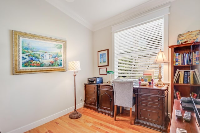 home office featuring light hardwood / wood-style floors, a wealth of natural light, and crown molding