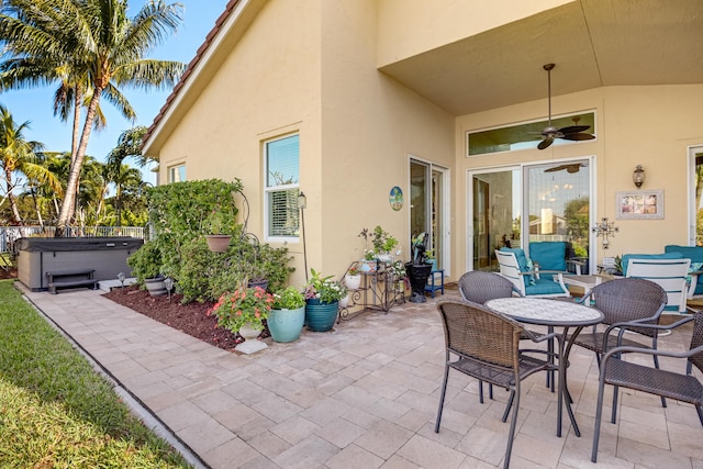 view of patio / terrace featuring a hot tub and ceiling fan