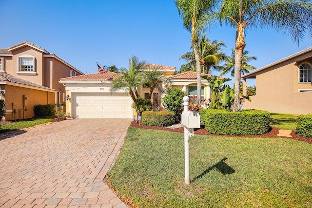 mediterranean / spanish-style home featuring a garage and a front lawn