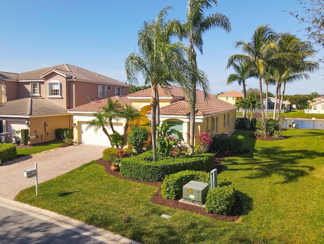 mediterranean / spanish-style house featuring a front yard