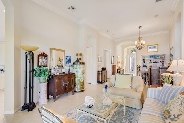 living room with a notable chandelier, light tile patterned floors, and crown molding