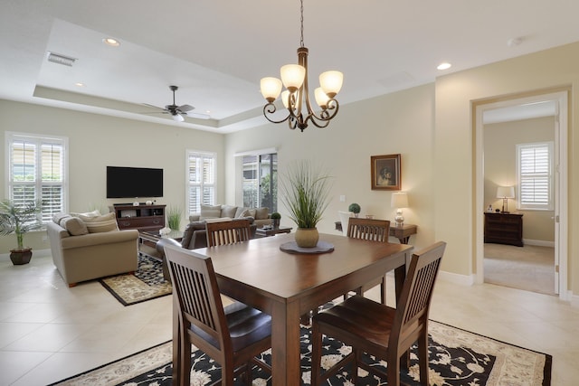 dining area featuring a wealth of natural light, a raised ceiling, light tile patterned flooring, and recessed lighting