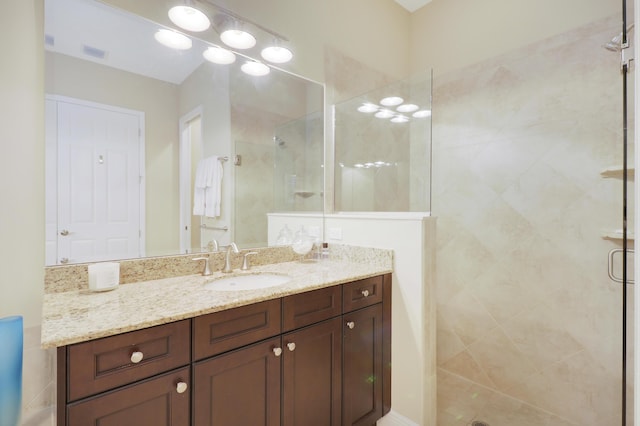 bathroom featuring a shower stall, visible vents, and vanity