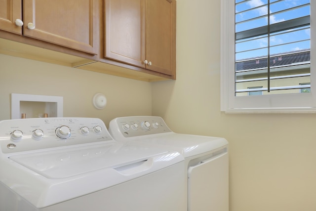 laundry room with cabinets and washing machine and clothes dryer