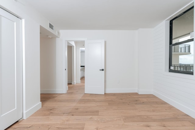 unfurnished room with light wood-type flooring