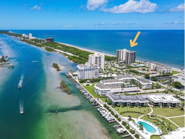 drone / aerial view with a beach view and a water view