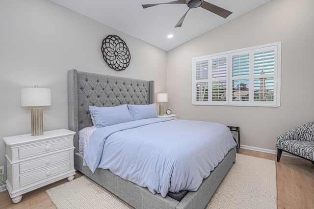 bedroom with light wood-type flooring, vaulted ceiling, and ceiling fan