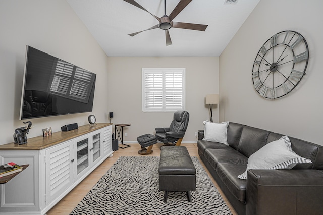 living room featuring light hardwood / wood-style floors, ceiling fan, and lofted ceiling