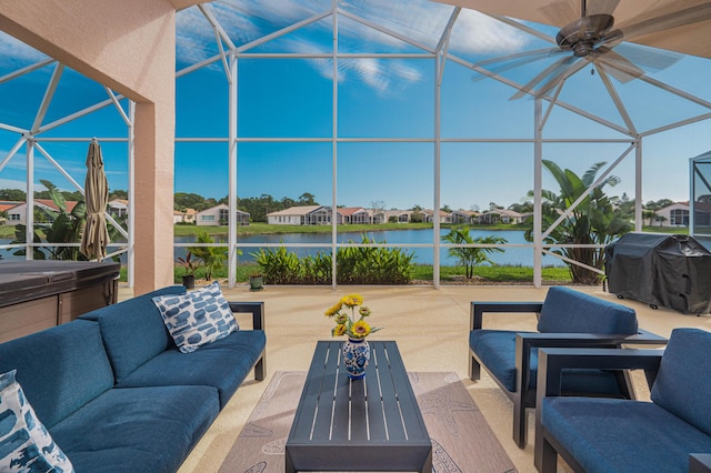 view of patio featuring a lanai, a grill, a water view, and a hot tub