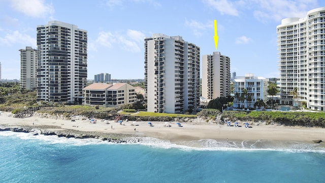 bird's eye view featuring a view of the beach and a water view