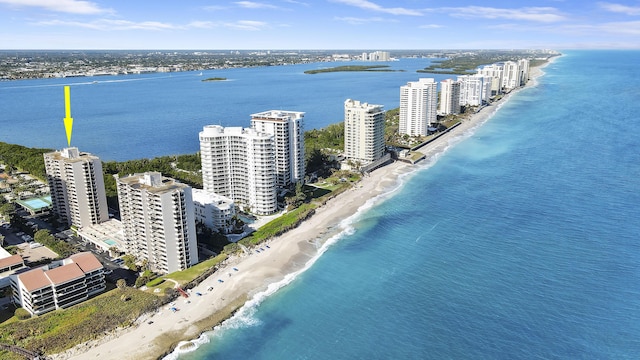 birds eye view of property with a city view, a water view, and a beach view