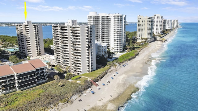 birds eye view of property featuring a water view, a beach view, and a city view