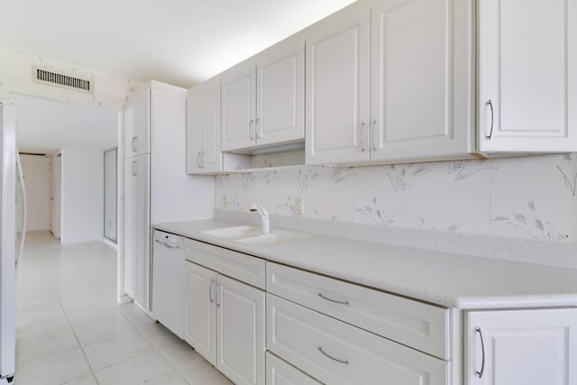 kitchen featuring light countertops, visible vents, white cabinetry, a sink, and white dishwasher