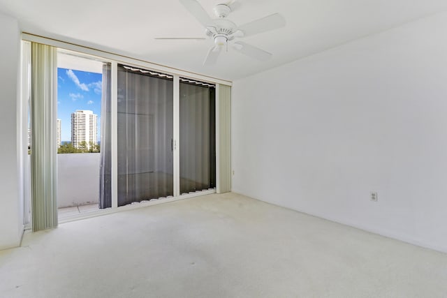 empty room featuring carpet and a ceiling fan