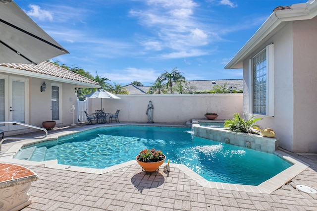 view of swimming pool with a patio and pool water feature