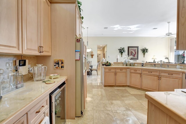 kitchen with wine cooler, light brown cabinets, and pendant lighting