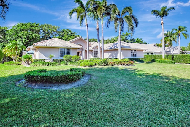 ranch-style home featuring a front lawn