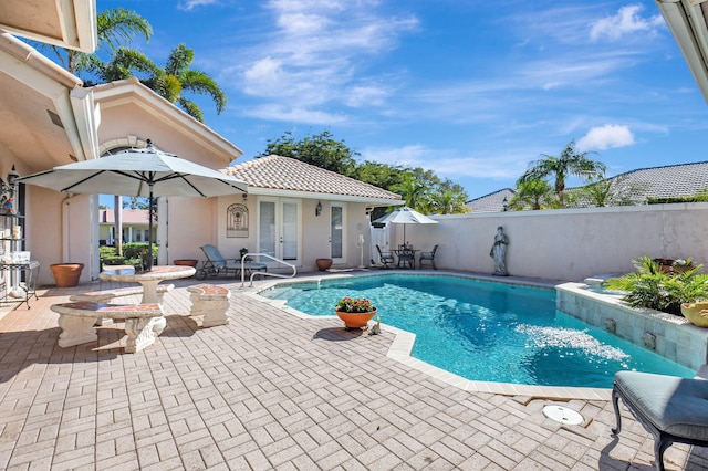 view of pool featuring french doors and a patio area