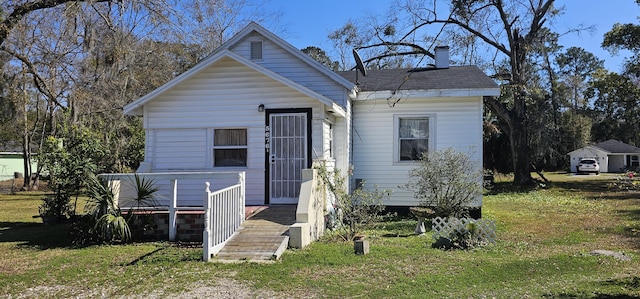 bungalow-style home featuring a front yard