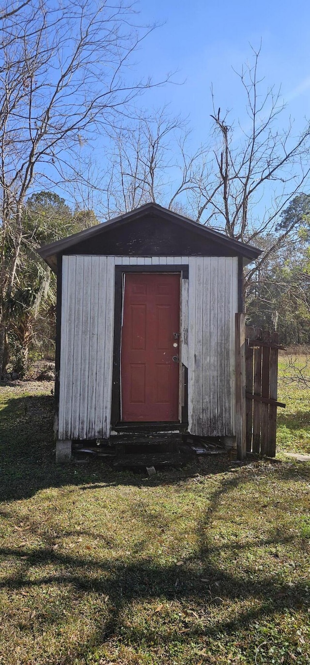 view of outbuilding with a lawn