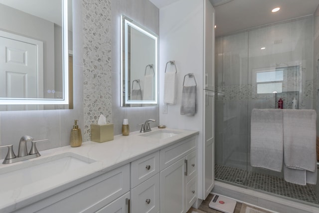 bathroom with vanity and a shower with shower door