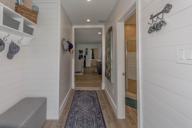 interior space featuring light hardwood / wood-style flooring and wooden walls