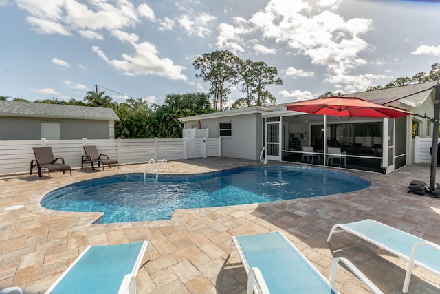 view of swimming pool featuring a patio area and a sunroom