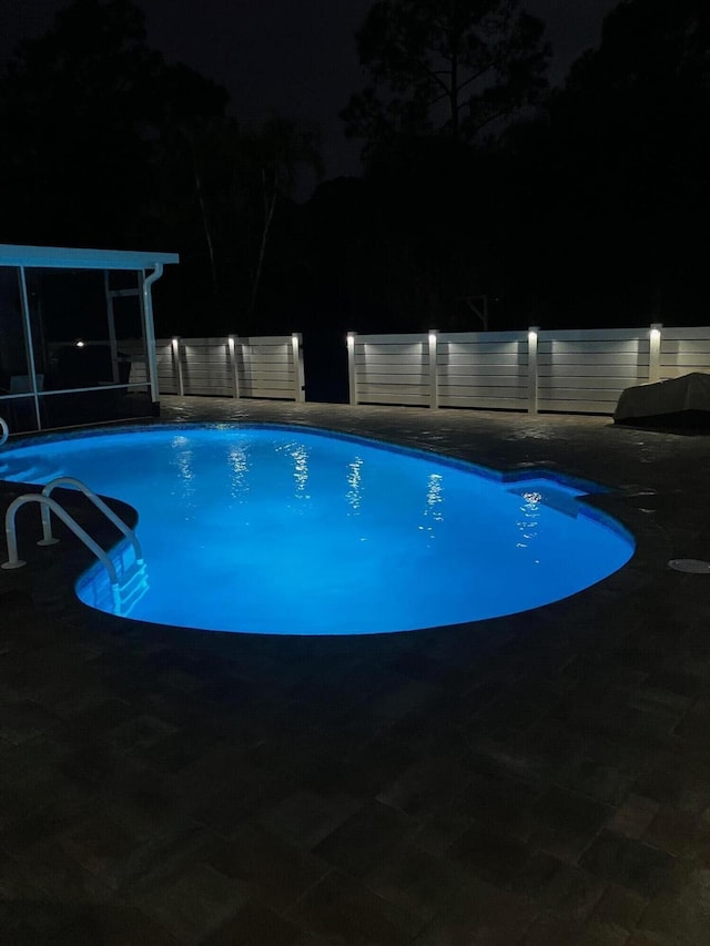 view of pool at night