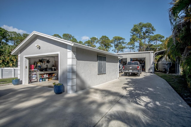 view of property exterior with a garage and an outdoor structure